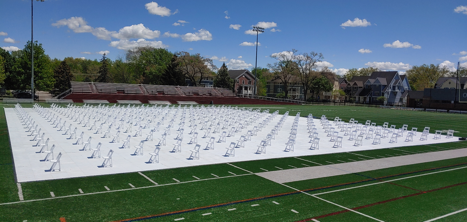 Large-scale outdoor commencement on university athletic field