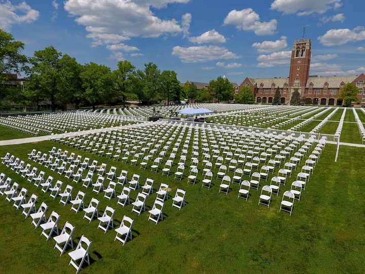 Large-scale graduation ceremony seating arrangement on campus field