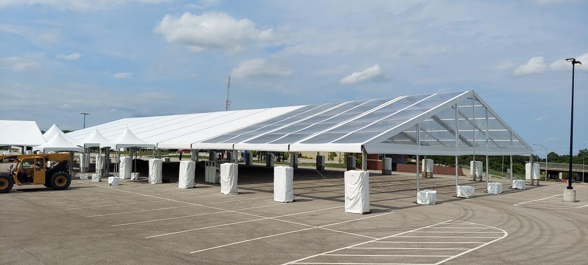 Large clearspan tent structure in parking lot for corporate event