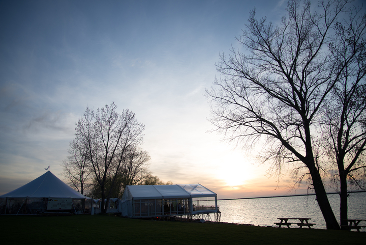 Lakefront corporate event tents at sunset