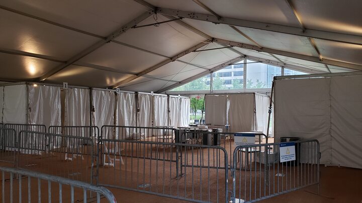 Interior of emergency tent facility with safety barriers and controlled access