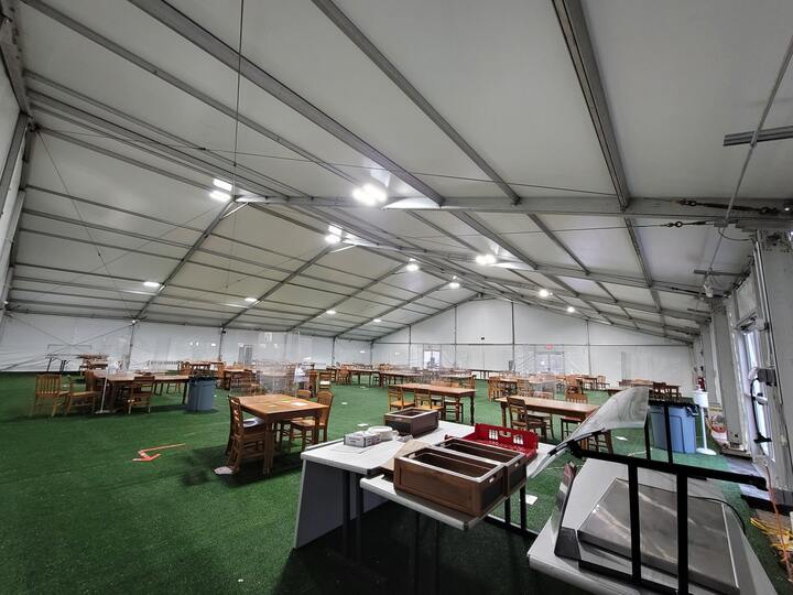 Emergency shelter interior with tables and seating setup for displaced populations