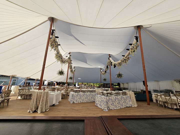 Sailcloth tent interior with elegant raised flooring and floral decorations