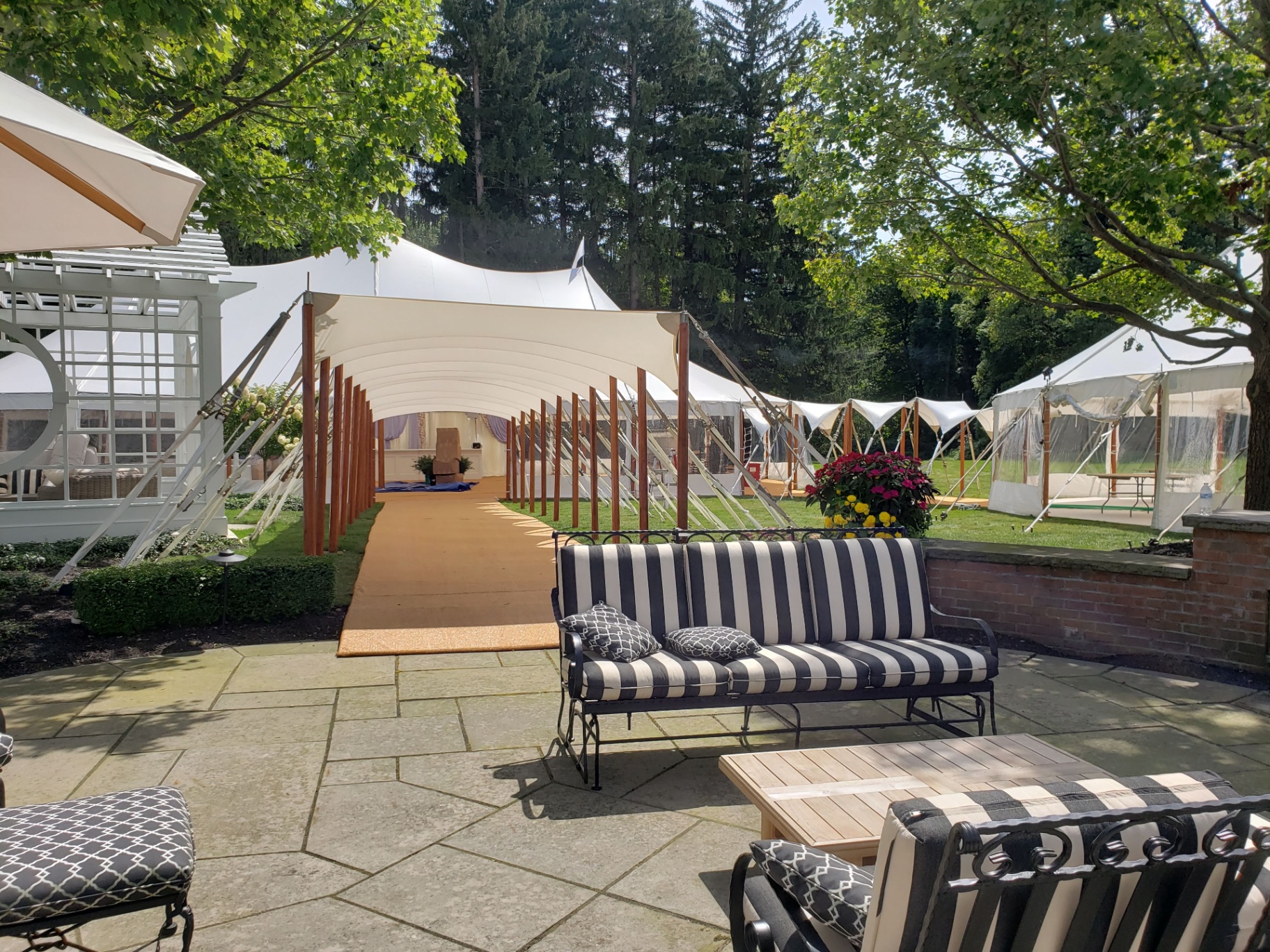 Sailcloth tent with premium on-grade flooring and elegant outdoor seating