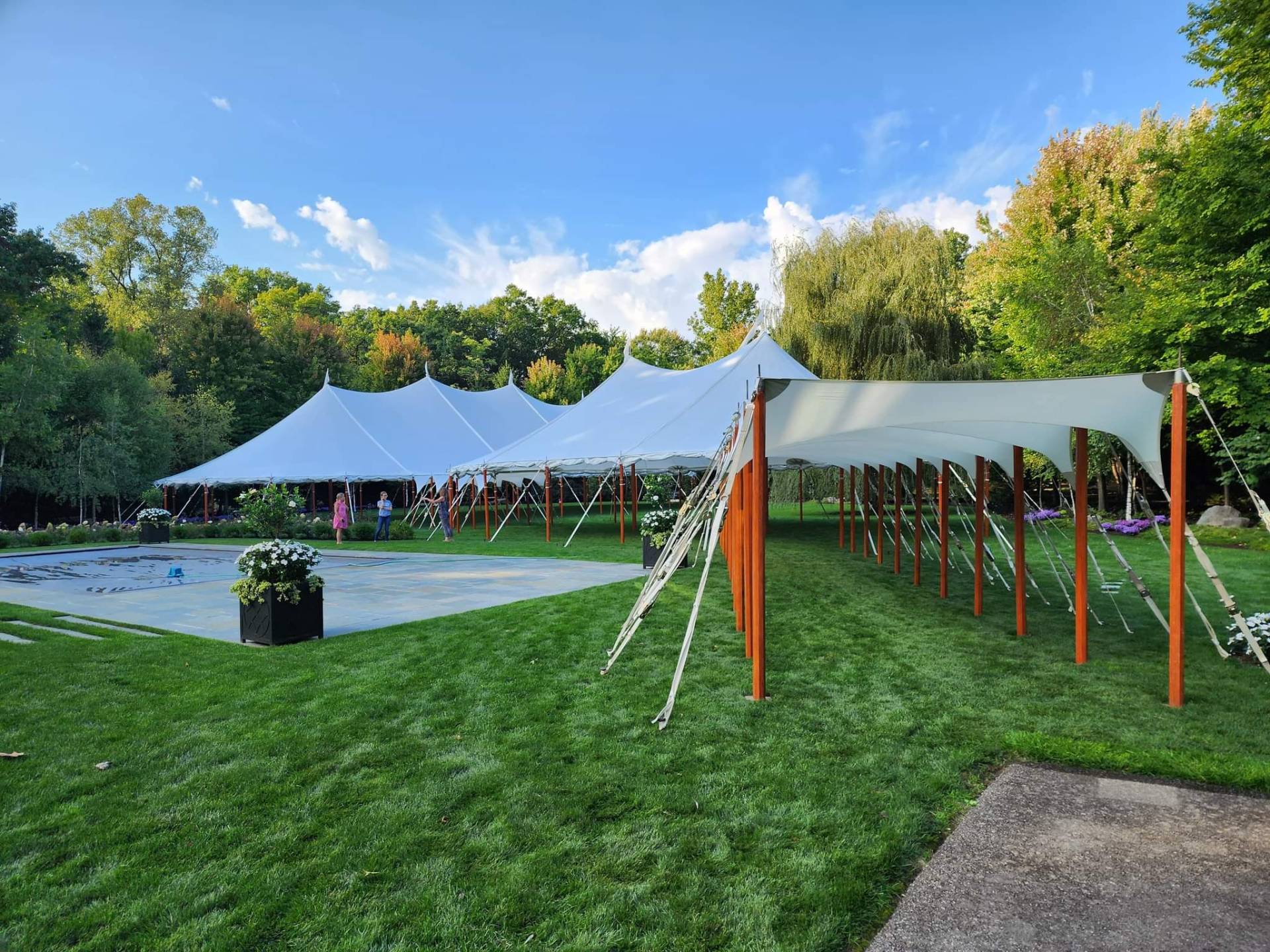 Luxury poolside wedding tent with elegant chandelier setup